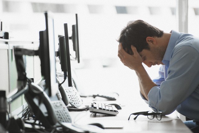 Tired office worker --- Image by © Hiya Images/Corbis